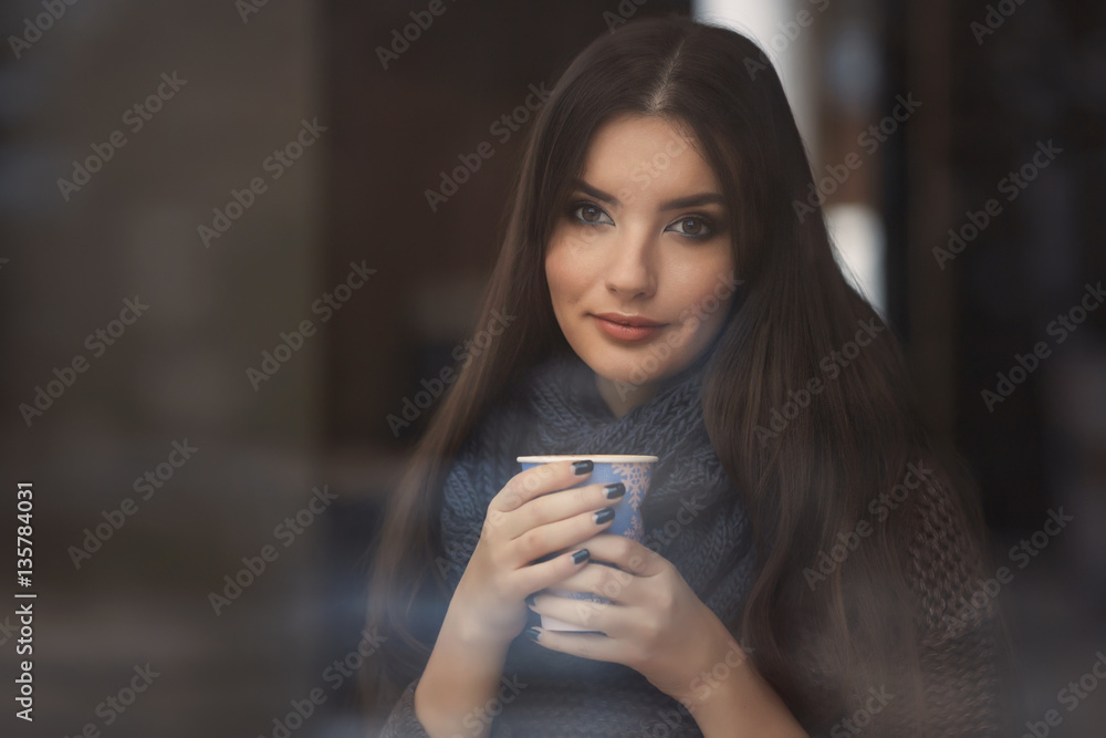 Portrait of a beautiful young woman enjoys a cup of coffee at morning Portrait of a beautiful young woman enjoys a cup of coffee at morning