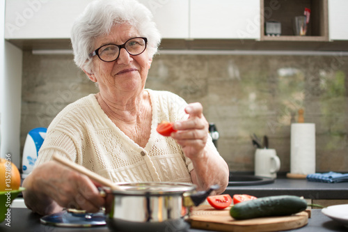 Senior woman cooking in the kitchen.