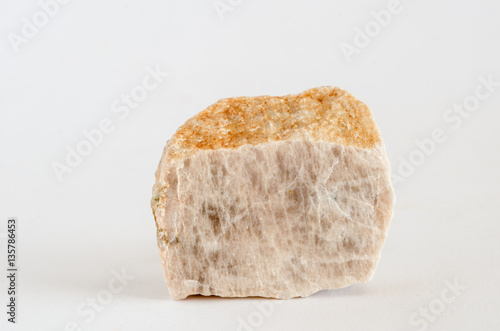 Piece of orthoclase ore on white background photo
