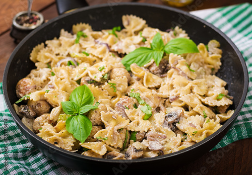 Pasta with meatballs and mushrooms in creamy sauce