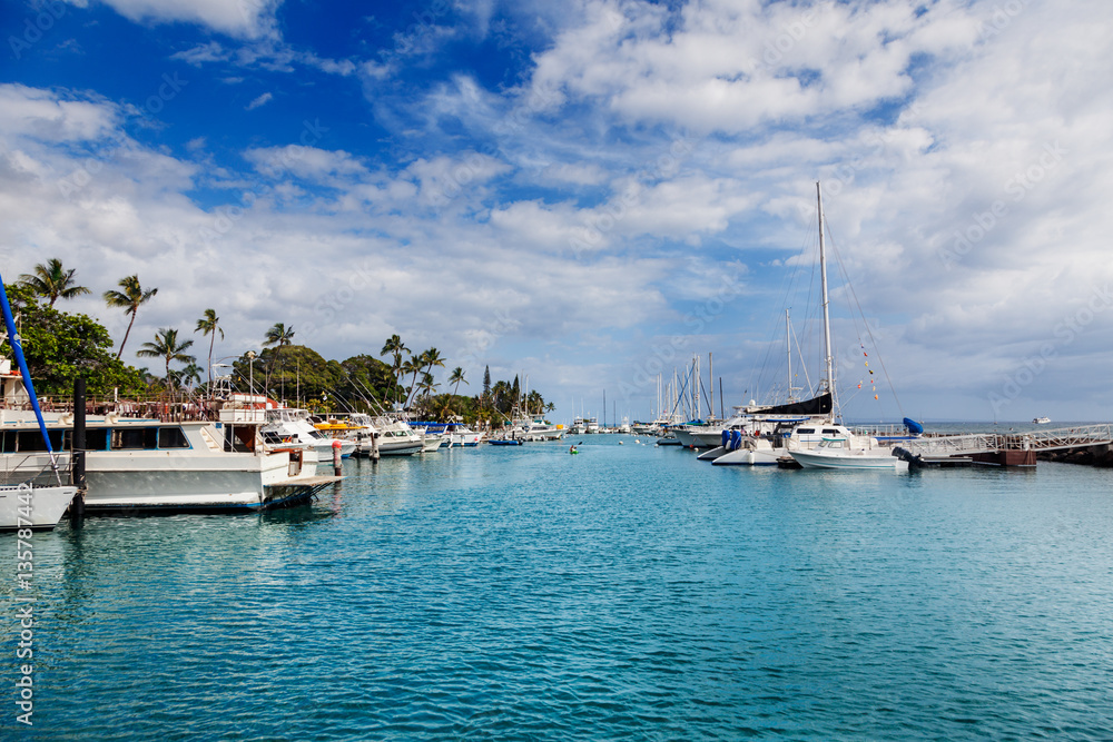 Kayak dwarfed by larger boats in Lahaina Maui Kayak dwarfed by larger boats in Lahaina Maui