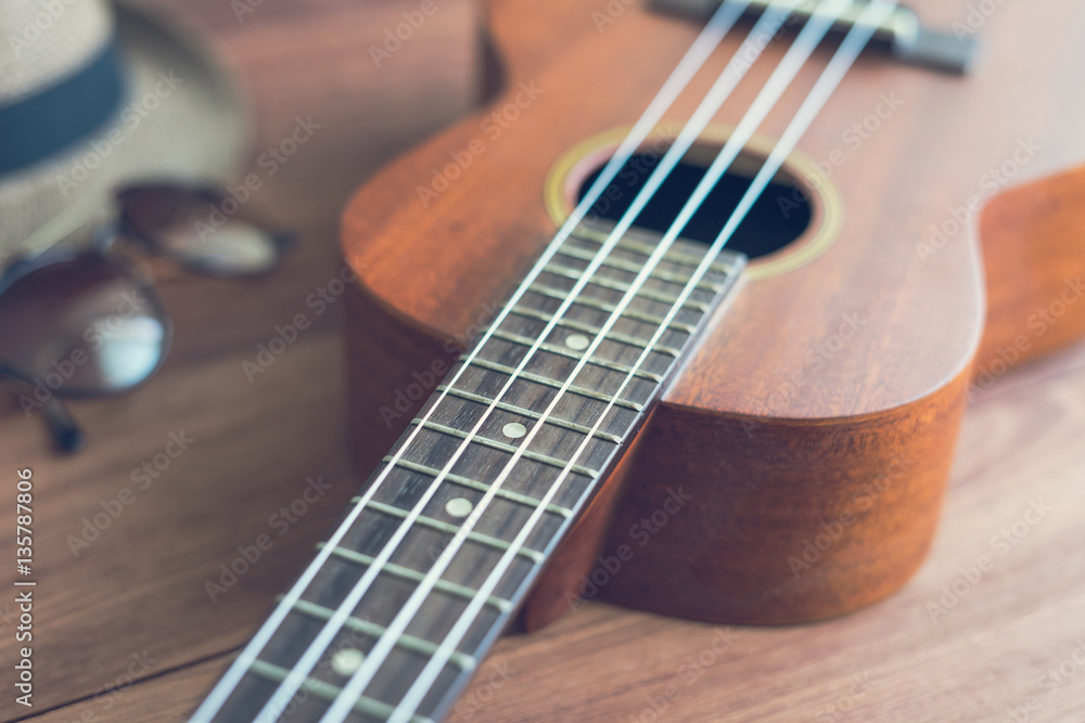 Fototapeta premium Ukulele guitar on wooden table