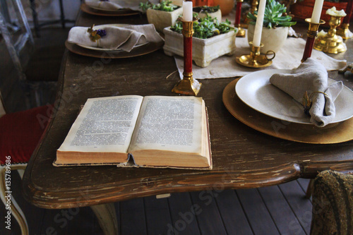 book with open pages lies at the dinner table