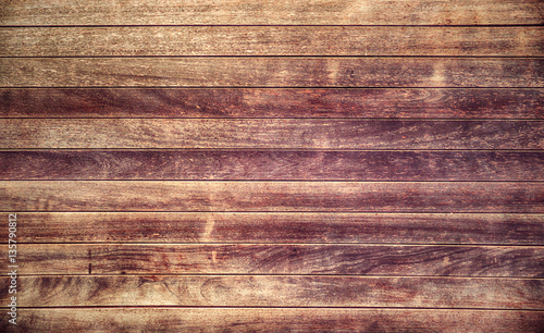 Weathered wood planks wall background with purple stains 