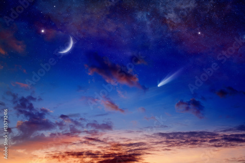 Bright comet, falling star and crescent in glowing sunset sky. Elements of this image furnished by NASA © IgorZh