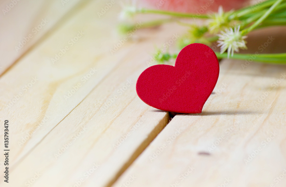 Closeup heart on the wood table with flower background,Valentine's day. Closeup heart on the wood table with flower background,Valentine's day.
