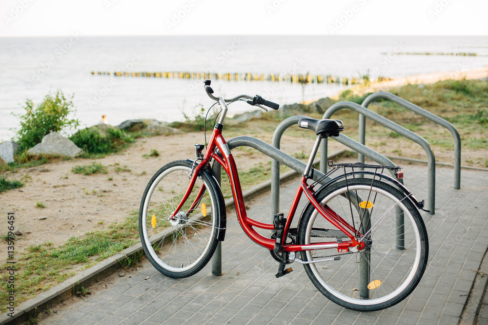 Bicycle parked on the bike parking near sea. Bicycle parked on the bike parking near sea.