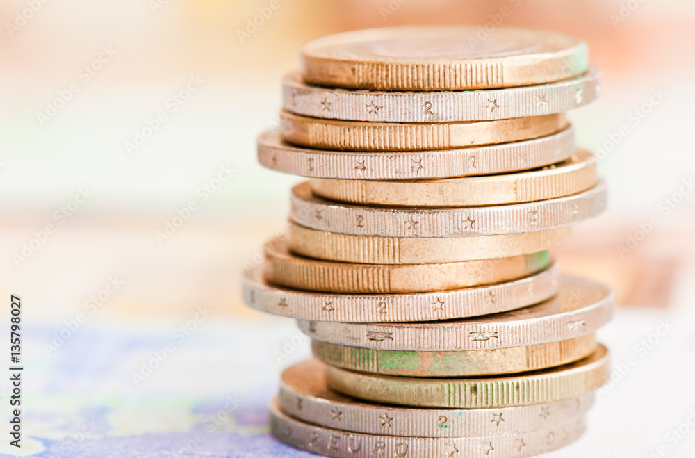 Money. Euro coins against euro banknotes background Money. Euro coins against euro banknotes background