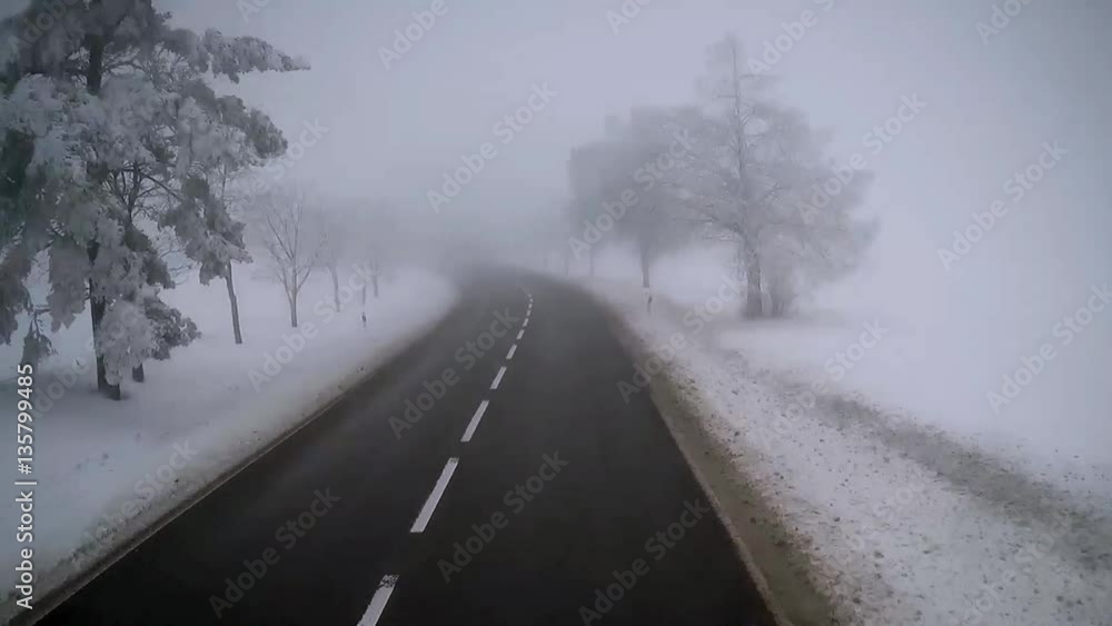 Exclusive view from truck driver`s cab. Accelerated motion footage of driving truck on empty road in foggy winter day Exclusive view from truck driver`s cab. Accelerated motion footage of driving truck on empty road in foggy winter day