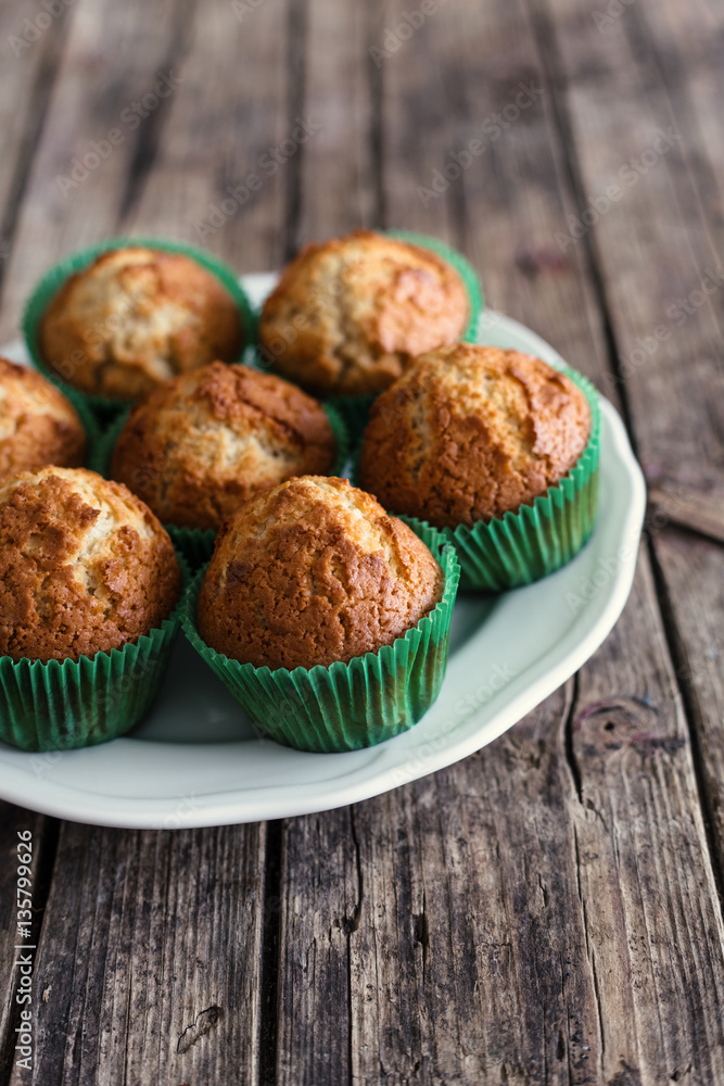 Muffins with yogurt on wooden background Muffins with yogurt on wooden background