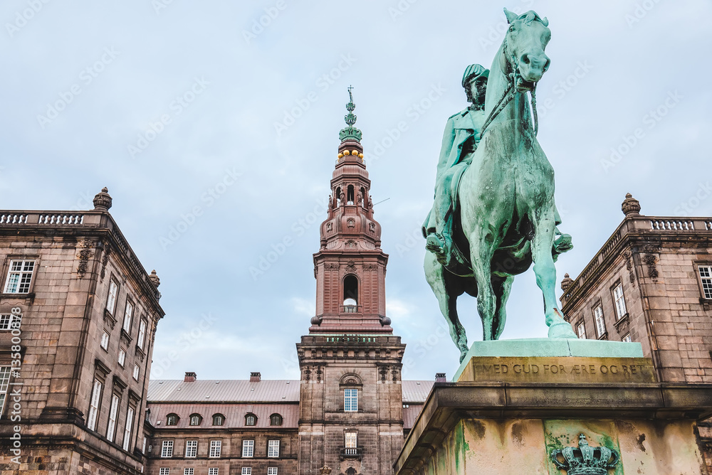 Christiansborg palace and King Christian IX statue in Copenhagen, Denmark. Famous landmark of danish capital. The seat of parliament on Slotsholmen.