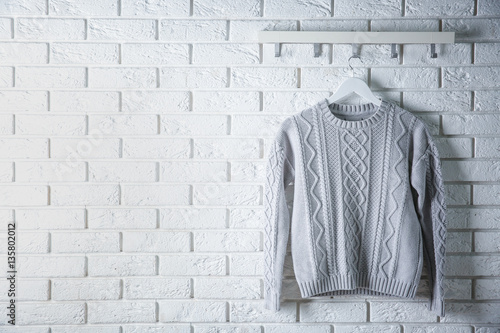 Sweater hanging on brick wall