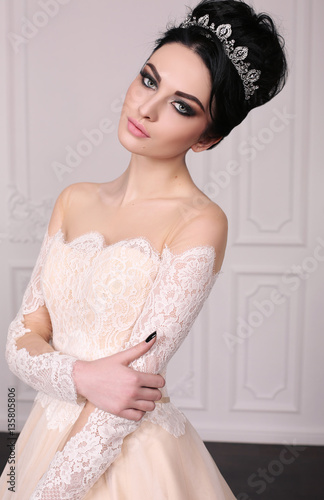 gorgeous bride with dark hair in luxuious wedding dress photo