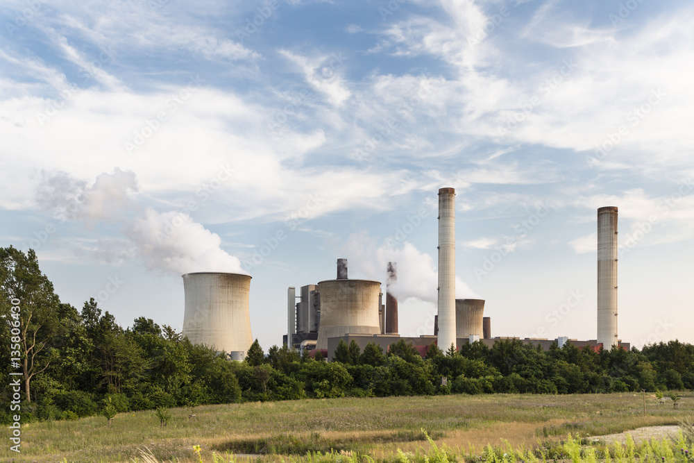 Power Plant Behind Field And Trees