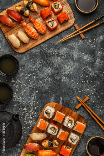 Sushi Set: sushi and sushi rolls on wooden plate.