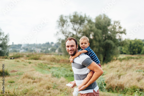 Father and son in nature in summer park
