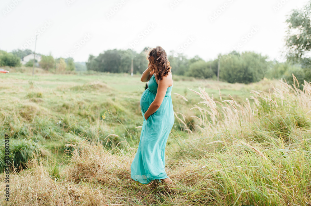 Pregnant woman walking in park Pregnant woman walking in park