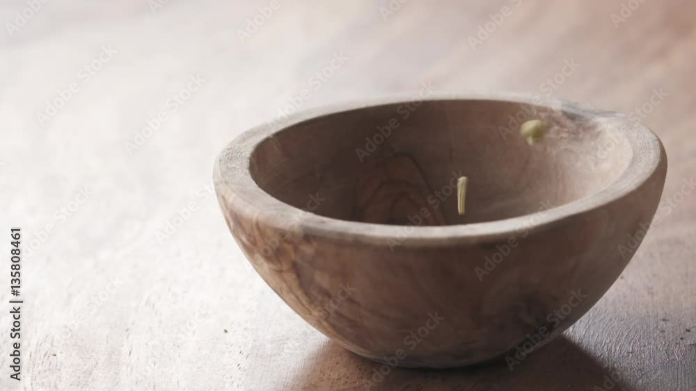 provence herbs falling in wood bowl on wooden table in slow motion, 180fps prores footage provence herbs falling in wood bowl on wooden table in slow motion, 180fps prores footage