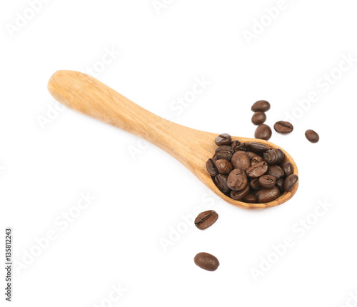Wooden spoon full of coffee isolated