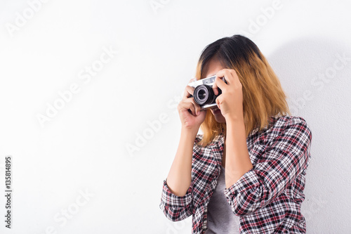 Young beautiful hipster woman with an old retro camera.