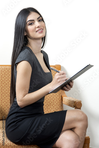 Secretary smiling while taking notes.