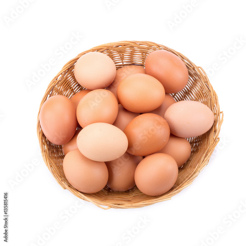 Eggs in basket isolated on white background.
