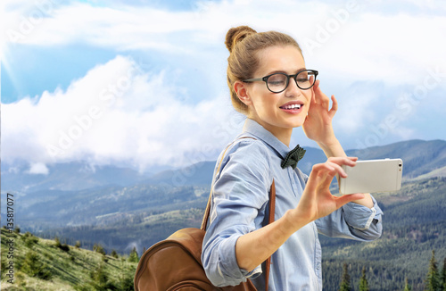 Young woman taking selfie o...