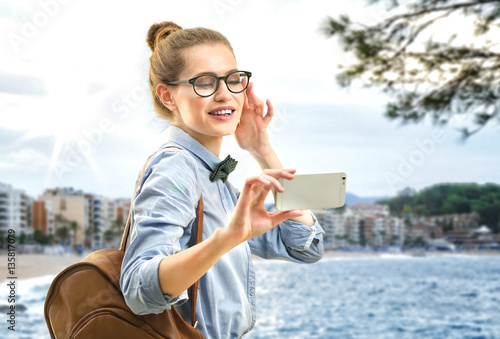 Young woman taking selfie o...