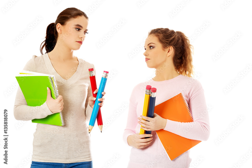 Young happy students posing over white background. Young happy students posing over white background.