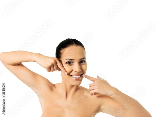 Dental health concept - beautiful woman pointing to her teeth
