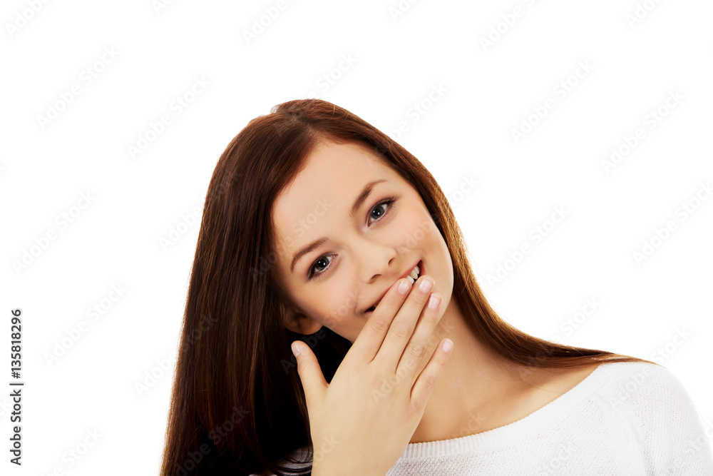 Young woman giggles covering her mouth with hand Young woman giggles covering her mouth with hand