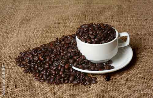 Coffee Beans roasted filled in white cup and plate