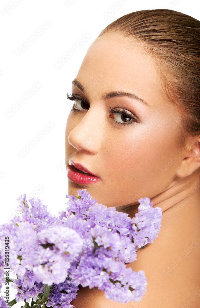 Fototapeta premium Sensual young spa woman holding flower.