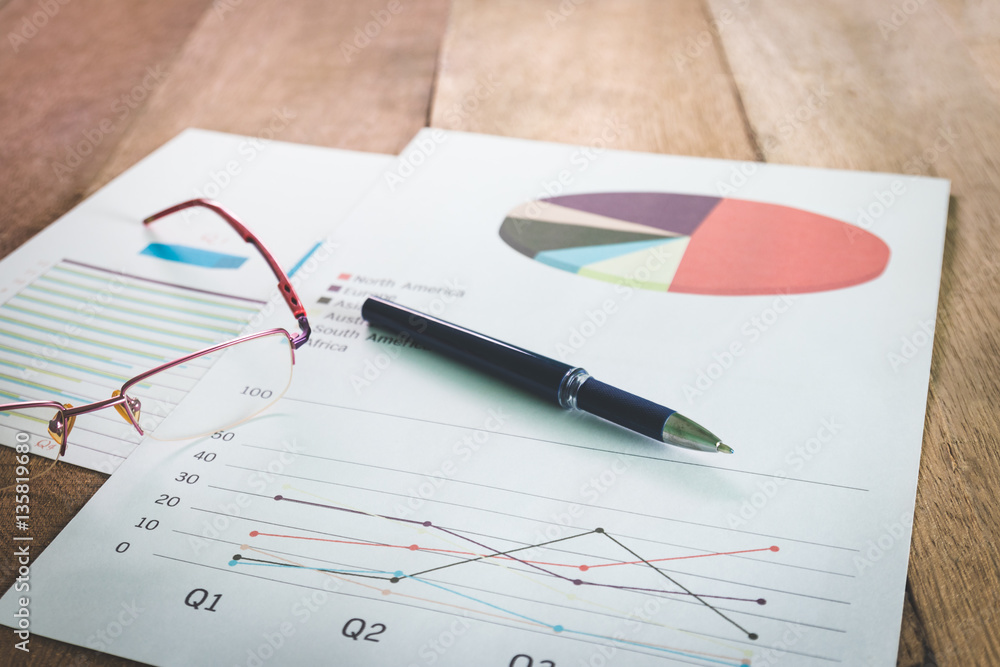 Close up pen with summary report and eyeglasses on table office. Concept of Data Analysis, Investment Planning, Business Analytics. Close up pen with summary report and eyeglasses on table office. Concept of Data Analysis, Investment Planning, Business Analytics.