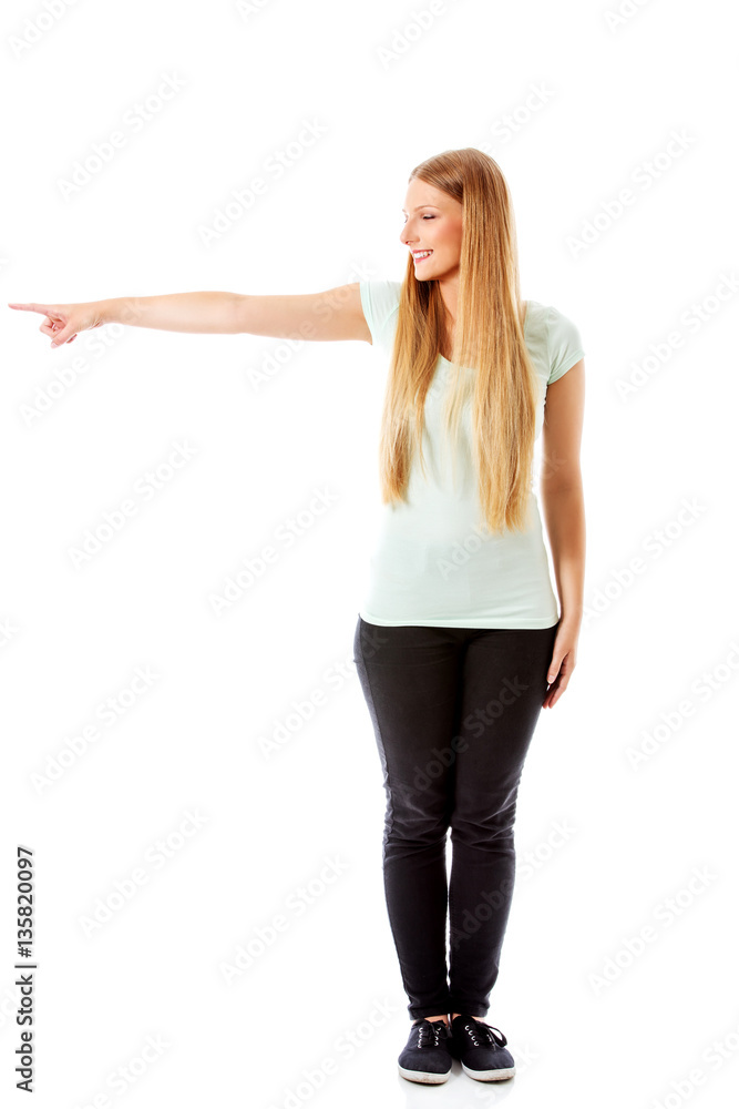Attractive woman looking and pointing sideways. Attractive woman looking and pointing sideways.