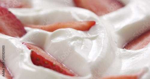 fresh sliced straberries in cream rotating background loopable, 4k prores footage photo