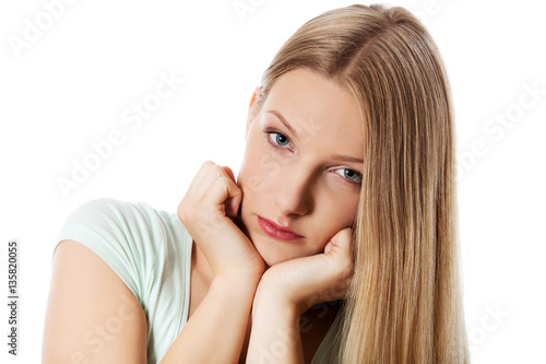 A young sad woman, isolated on white background.