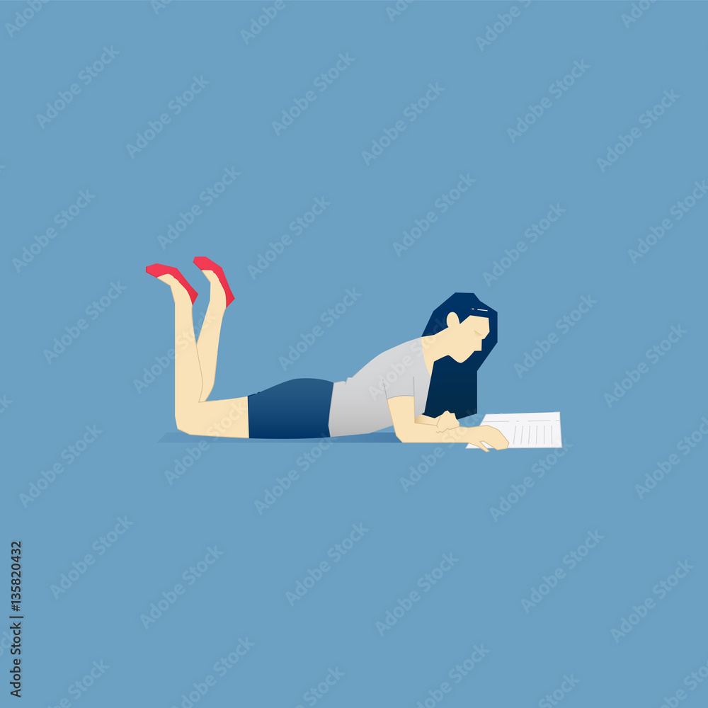 Young woman lying with an open book and reading Young woman lying with an open book and reading