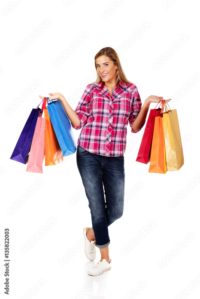 Young smiling woman holding shopping bags