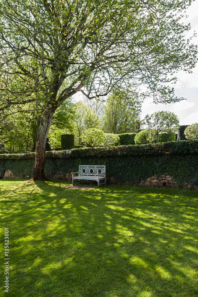 Shady Park Bench in the French Garden of Eyrignac in Salignac