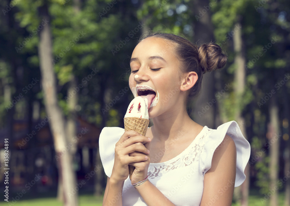 Girl eating ice cream in the park Girl eating ice cream in the park