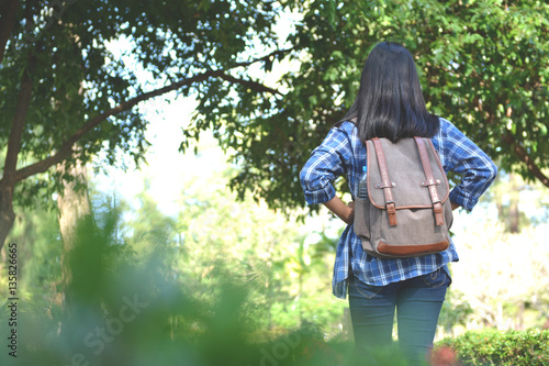 Happy Asian girl backpack in park and forest background, Relax time © sawitreelyaon