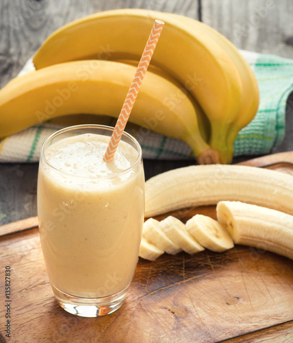 Banana smoothie on a rustic wooden table