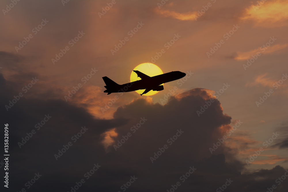 Silhouette of an airplane taking off on sunset background Silhouette of an airplane taking off on sunset background