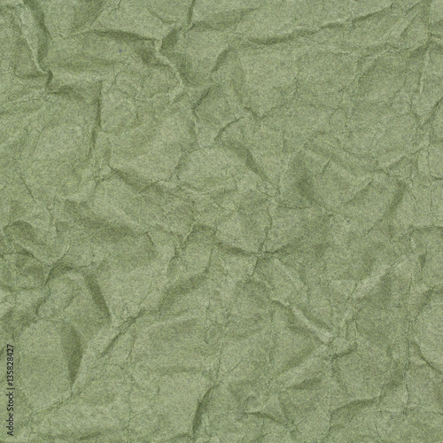 abstract background of crumpled green paper with blotches