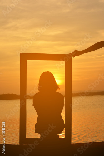 Silhouette of women in the frame at the sky sunset © sawitreelyaon
