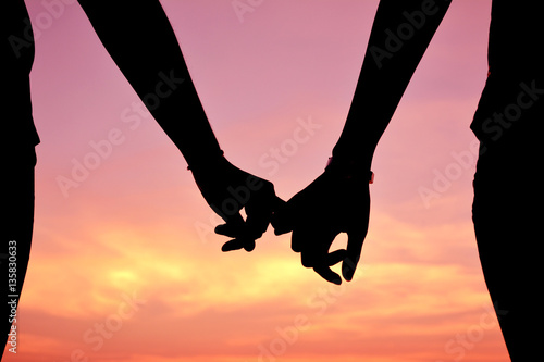 Obraz na plátně Silhouette women and man of lovers at the sky sunset, concept valentine  day