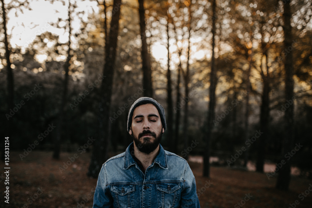 Man with eyes closed in the forest Man with eyes closed in the forest