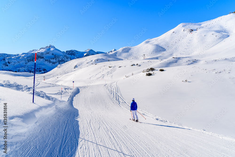 Skier on ski slope in Obertauern winter resort, Austria