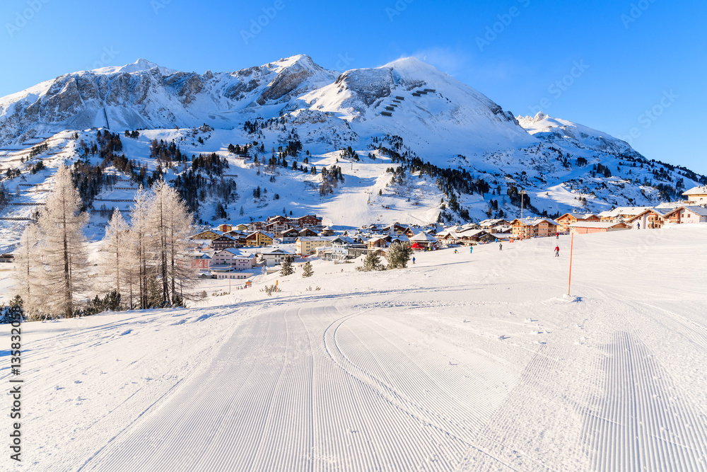 View of ski run and Obertauern mountain village in winter season, Austria